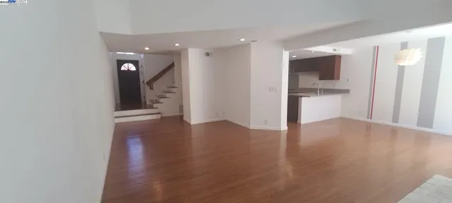 a view of a kitchen with a sink and a refrigerator