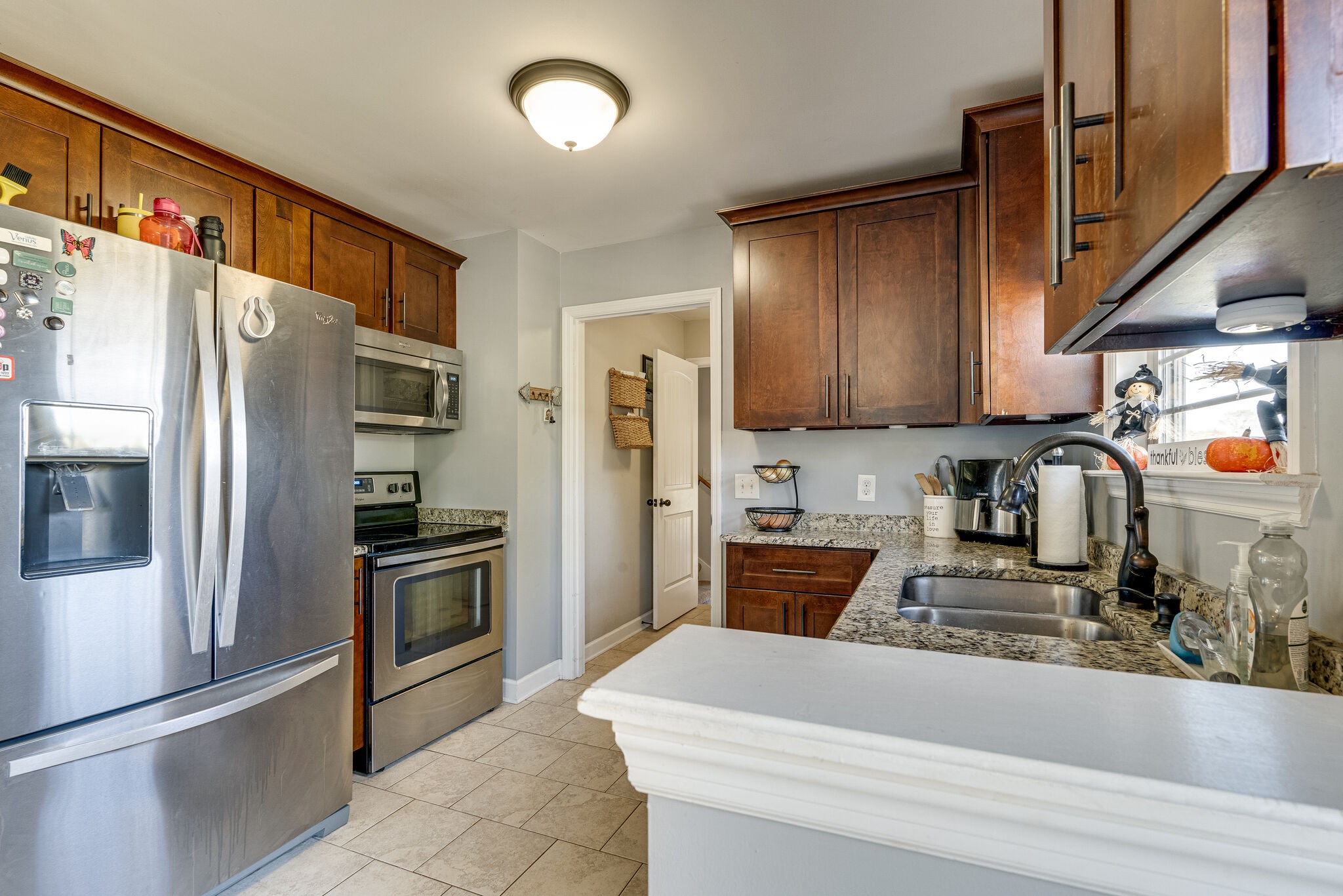 515 Neal Road Watertown, TN 37184 - Photo 12 of 30 a kitchen with stainless steel appliances granite countertop a refrigerator a stove and a sink with wooden floors