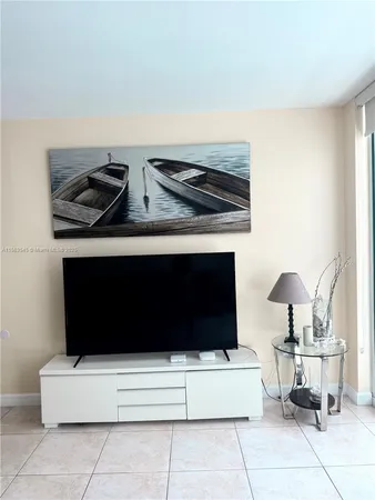 a bedroom with a bed and a chandelier fan