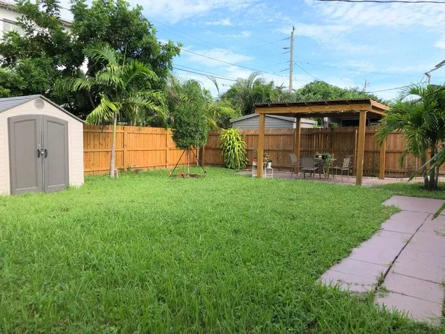 a view of a house with a yard and sitting area