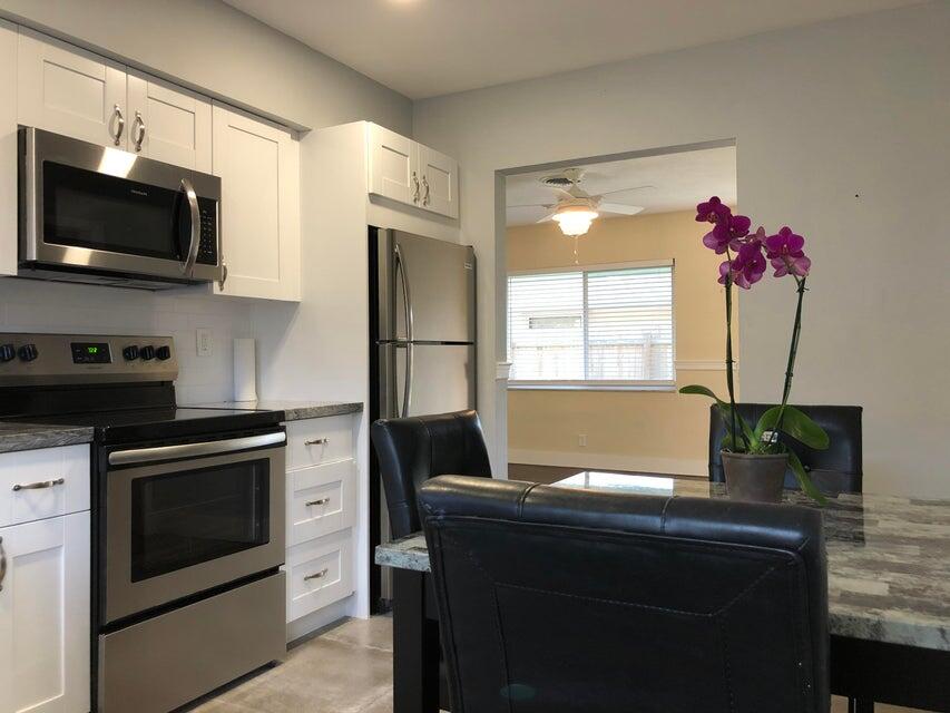 118 Northeast 4th Avenue Deerfield Beach, FL 33441 - Photo 2 of 11 a kitchen with a sink cabinets and window
