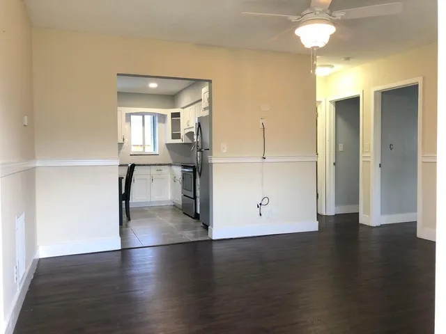 a view of a kitchen with a sink and a refrigerator
