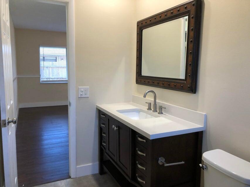 118 Northeast 4th Avenue Deerfield Beach, FL 33441 - Photo 8 of 11 a bathroom with a sink vanity and a mirror