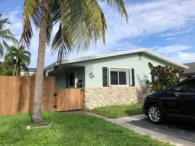 a view of a house with a car parked in front of a house