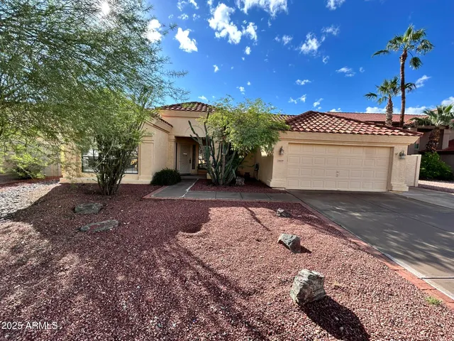 a view of a house with a yard and a garage