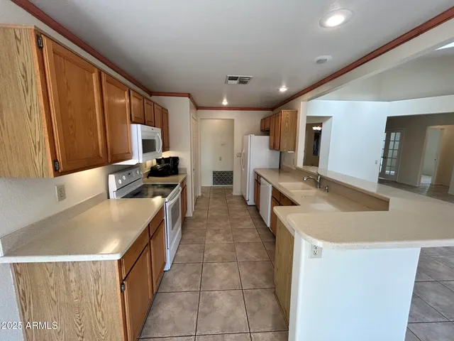 a kitchen with a sink refrigerator and microwave