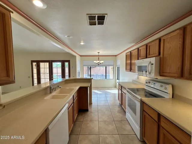 a kitchen with stainless steel appliances granite countertop a sink and a stove