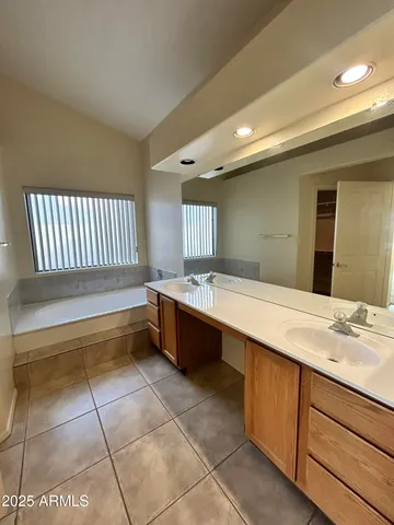 a spacious bathroom with a bathtub and a sink