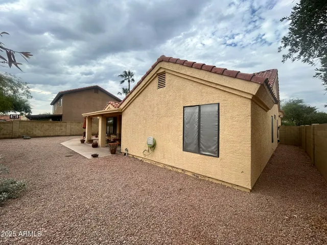 a view of a house with a backyard