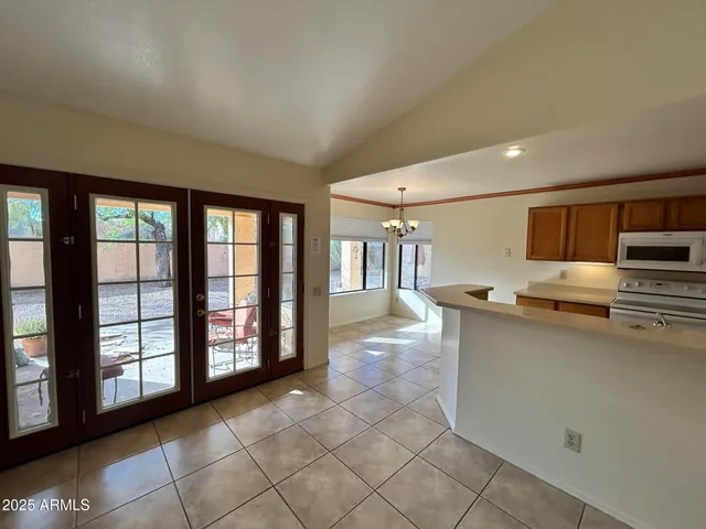 a open kitchen with stainless steel appliances granite countertop a refrigerator and a sink