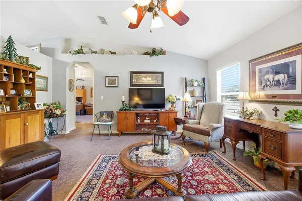 a living room with furniture a rug and a flat screen tv