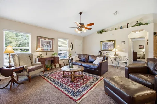 a living room with furniture and a chandelier