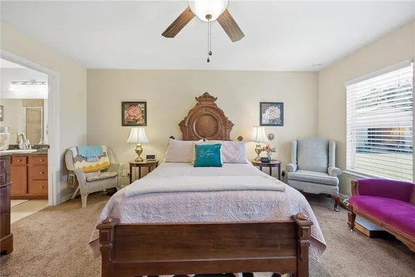 a bedroom with a bed couch and window