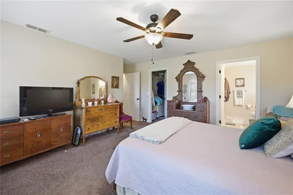 a bed room with furniture and a flat screen tv