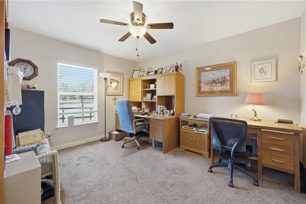 a view of a workspace with furniture and a window