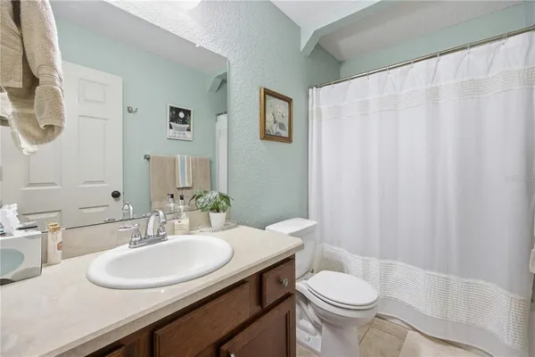 a bathroom with a sink toilet and a mirror
