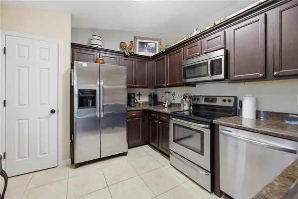 a kitchen with stainless steel appliances granite countertop a refrigerator stove and sink