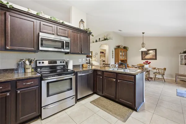 a kitchen with stainless steel appliances granite countertop a stove and cabinets
