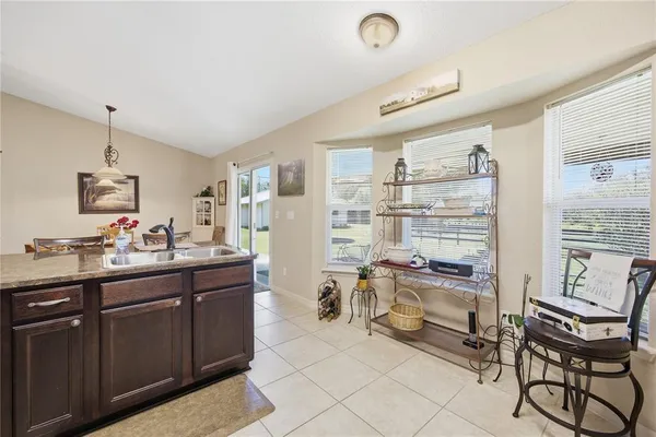 a kitchen with a sink and chairs