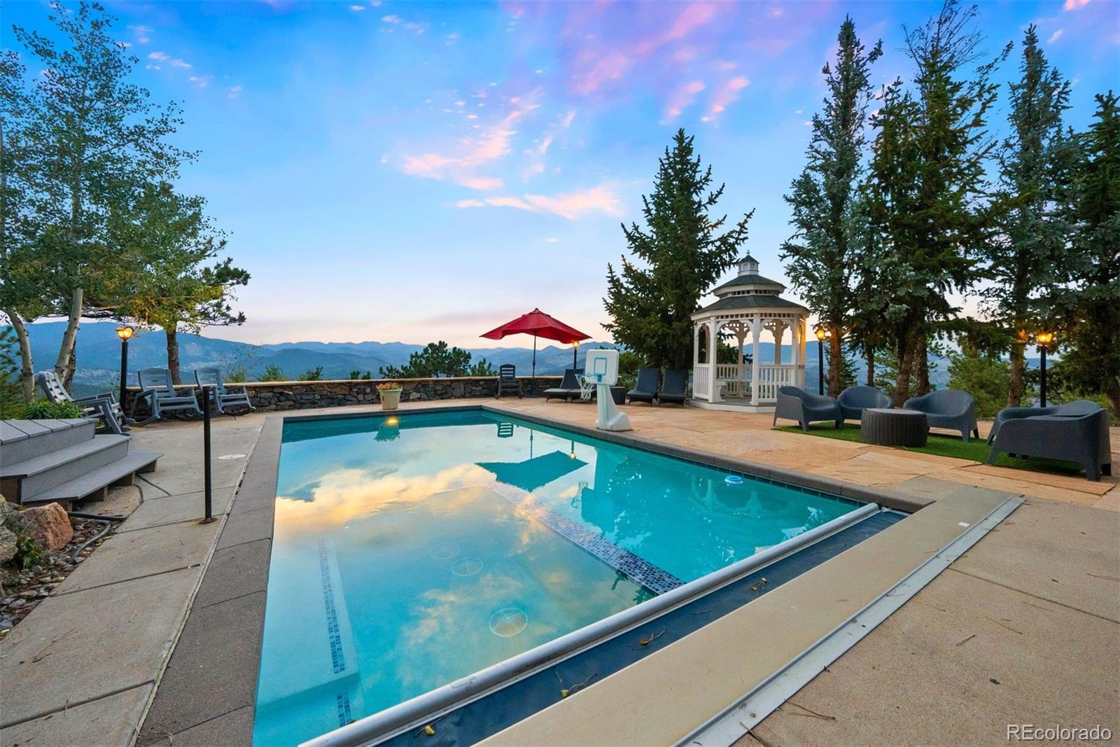 29115 Summit Ranch Drive Golden, CO 80401 - Photo 2 of 50 a swimming pool with outdoor seating and yard