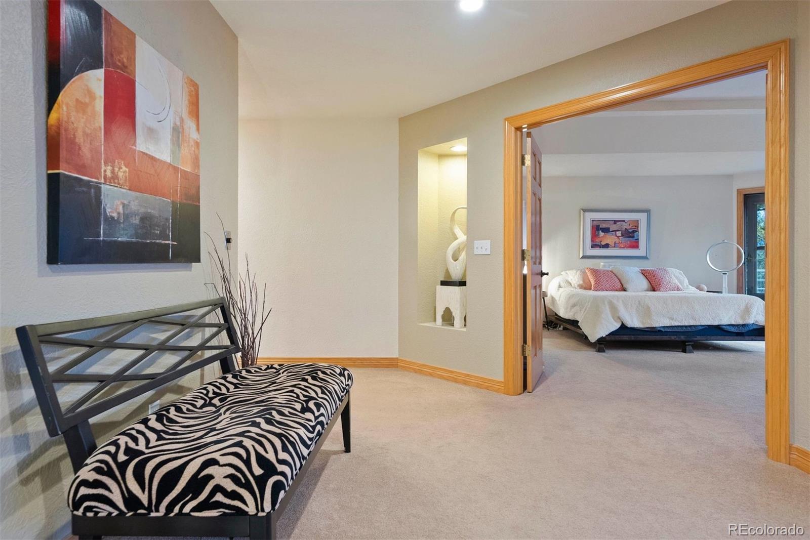 29115 Summit Ranch Drive Golden, CO 80401 - Photo 24 of 50 a bedroom with a bed and a painting on the wall