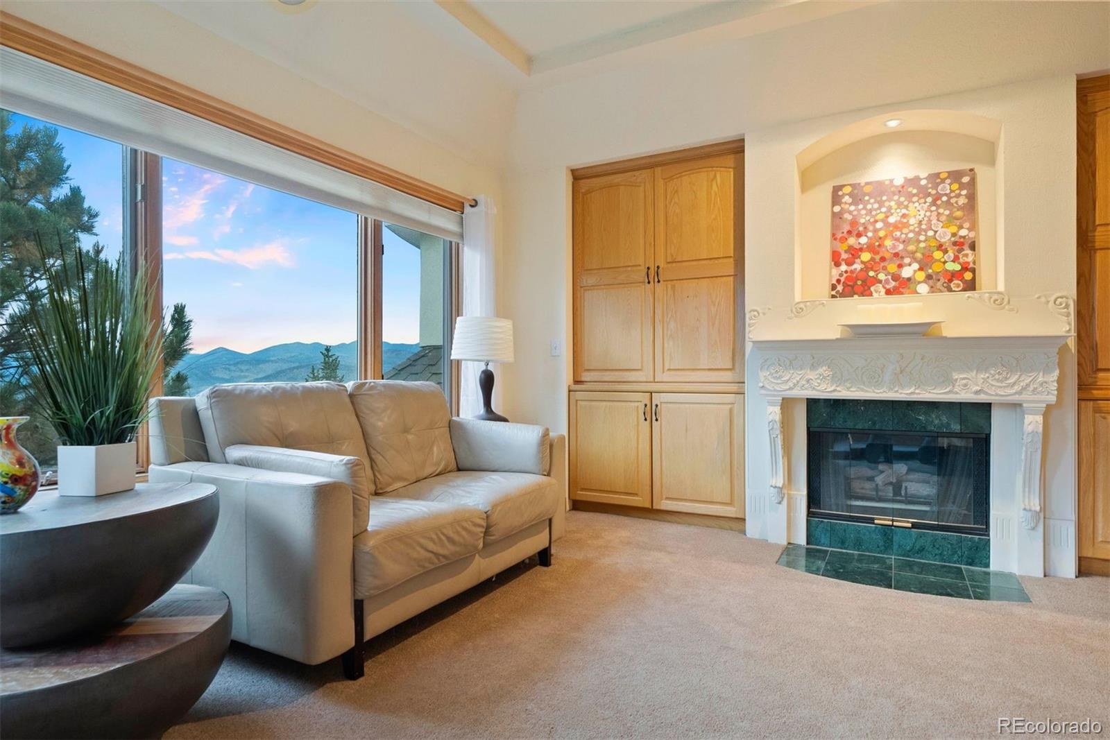 29115 Summit Ranch Drive Golden, CO 80401 - Photo 26 of 50 a living room with furniture and a fireplace