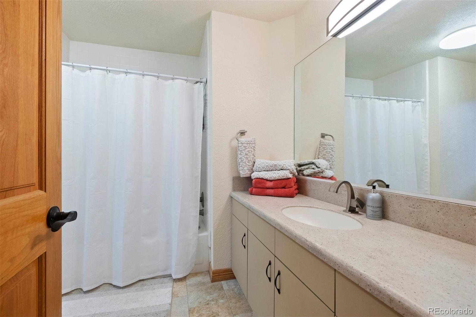 29115 Summit Ranch Drive Golden, CO 80401 - Photo 43 of 50 a bathroom with a sink and a mirror