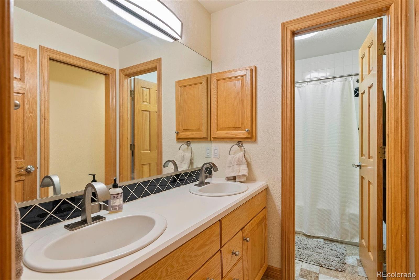 29115 Summit Ranch Drive Golden, CO 80401 - Photo 44 of 50 a bathroom with a sink and a mirror