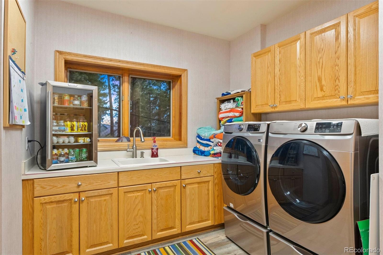 29115 Summit Ranch Drive Golden, CO 80401 - Photo 46 of 50 a utility room with sink dryer and washer