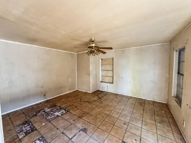 a view of a room with window and a ceiling fan
