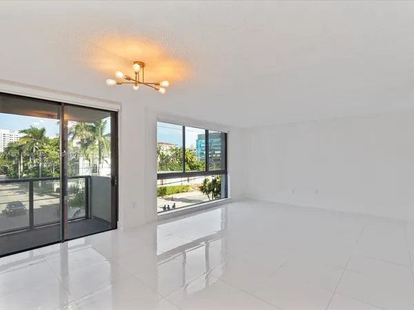 a living room with stainless steel appliances kitchen island furniture and window