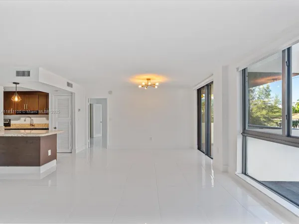 a view of a livingroom with a ceiling fan and window