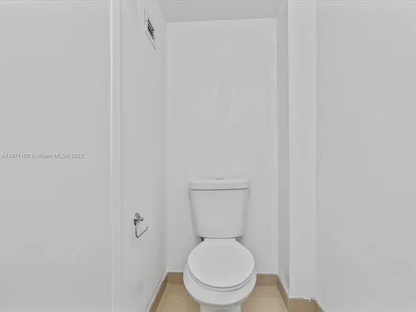 a bathroom with a sink toilet and a mirror