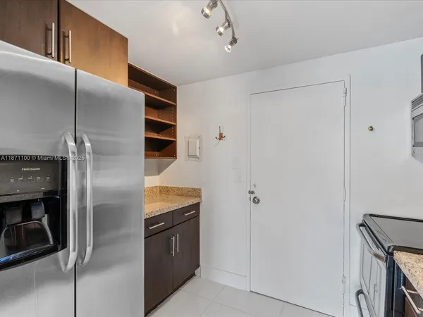 a kitchen with stainless steel appliances granite countertop a refrigerator and a sink