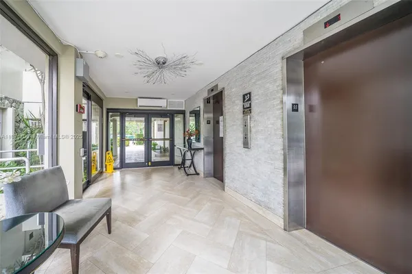 a view of a livingroom with furniture and a large window