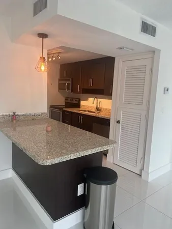 a kitchen with a table and chairs