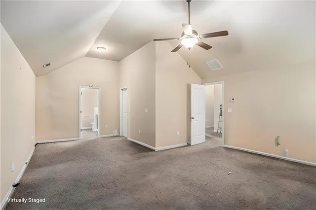 an empty room with a ceiling fan and a window