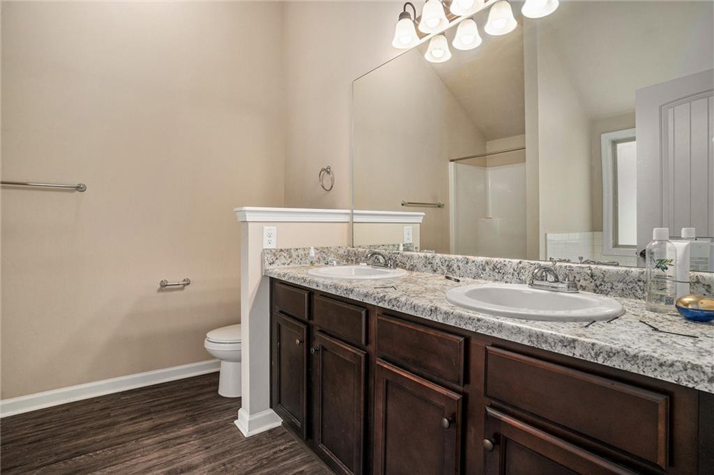 2277 Church Street Hampton, GA 30228 - Photo 17 of 30 a bathroom with a granite countertop sink and a mirror