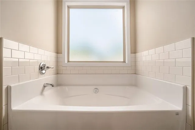 a white bath tub sitting next to a window