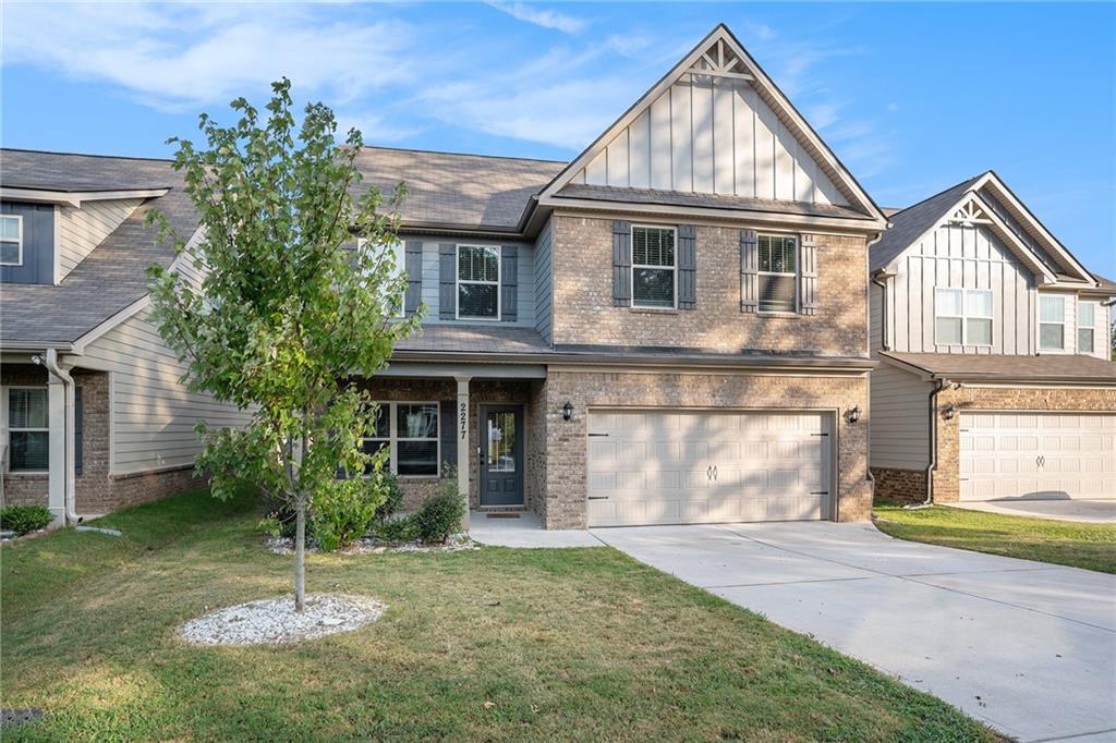 2277 Church Street Hampton, GA 30228 - Photo 2 of 30 a front view of a house with a yard and garage