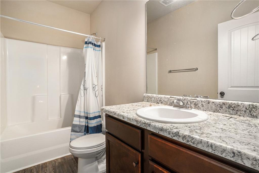2277 Church Street Hampton, GA 30228 - Photo 28 of 30 a bathroom with a granite countertop sink toilet and shower