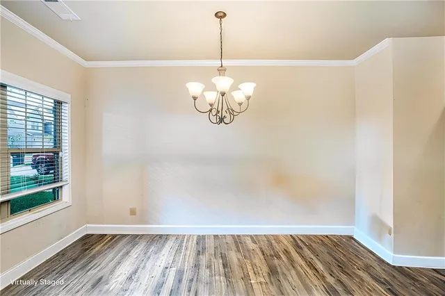 a view of a room with wooden floor fan and a window