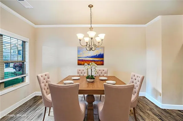 a dining room with furniture a rug and wooden floor