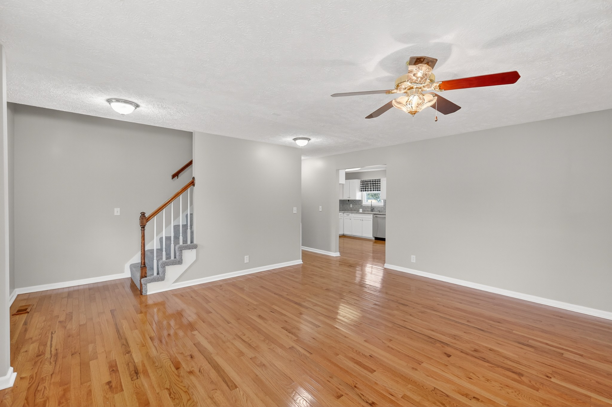 3145 Middleton Drive Rockvale, TN 37153 - Photo 7 of 50 a view of an empty room with wooden floor and a ceiling fan