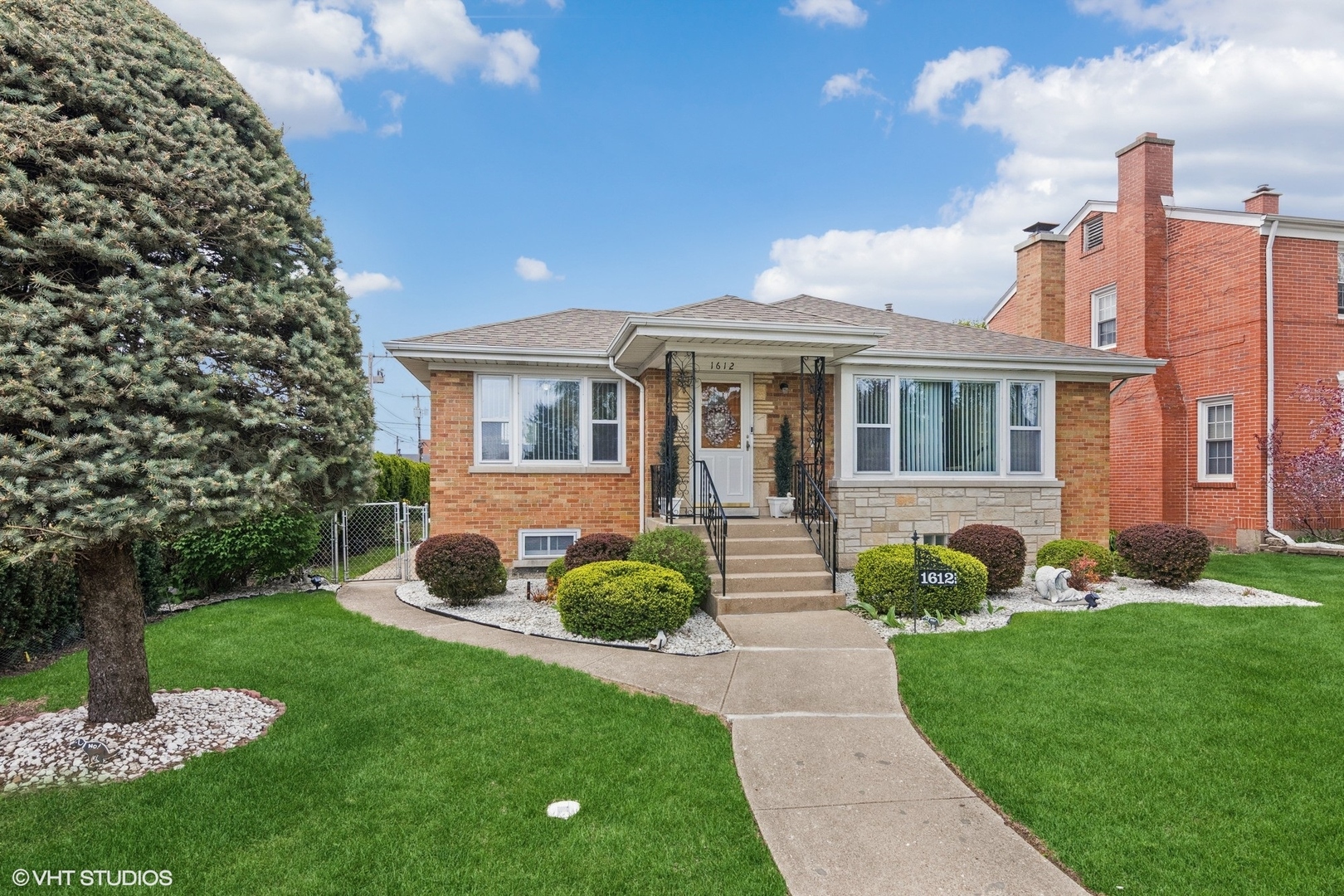 a front view of a house with garden