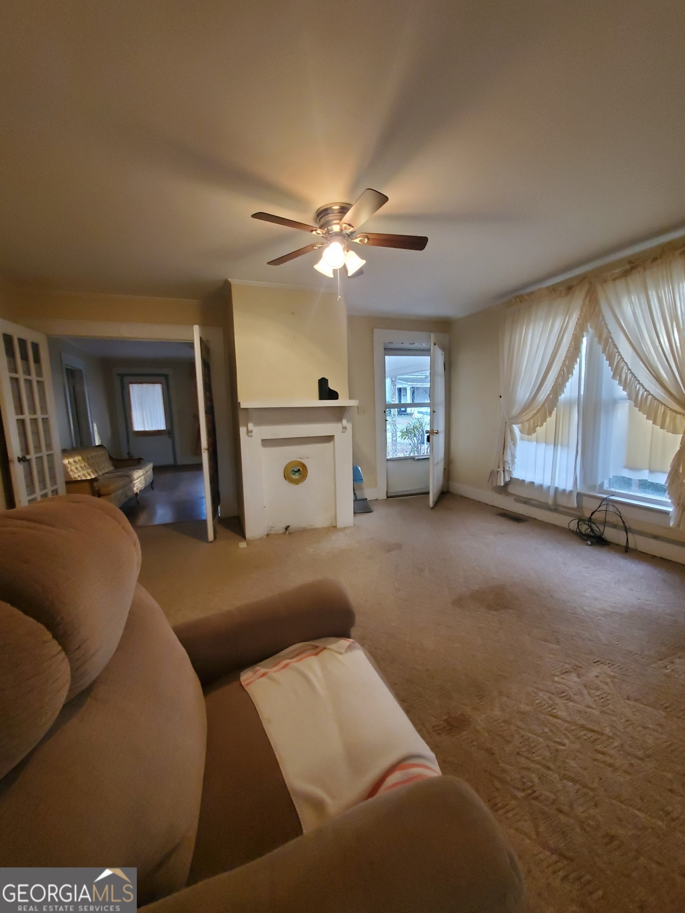 134 Adams Street Lavonia, GA 30553 - Photo 16 of 29 a living room with furniture and a chandelier