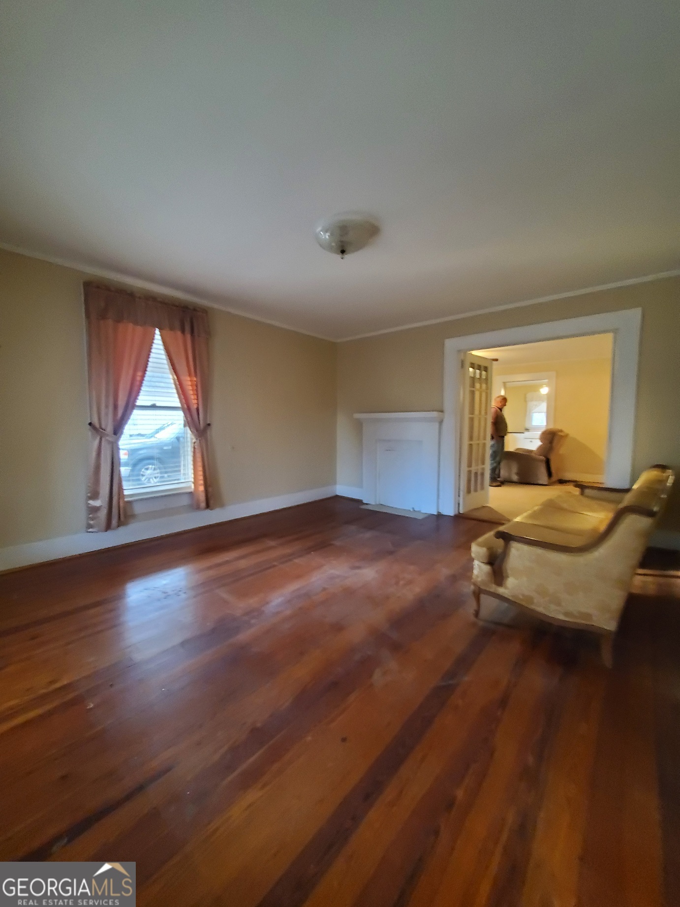 134 Adams Street Lavonia, GA 30553 - Photo 20 of 29 a bedroom with wooden floor and window