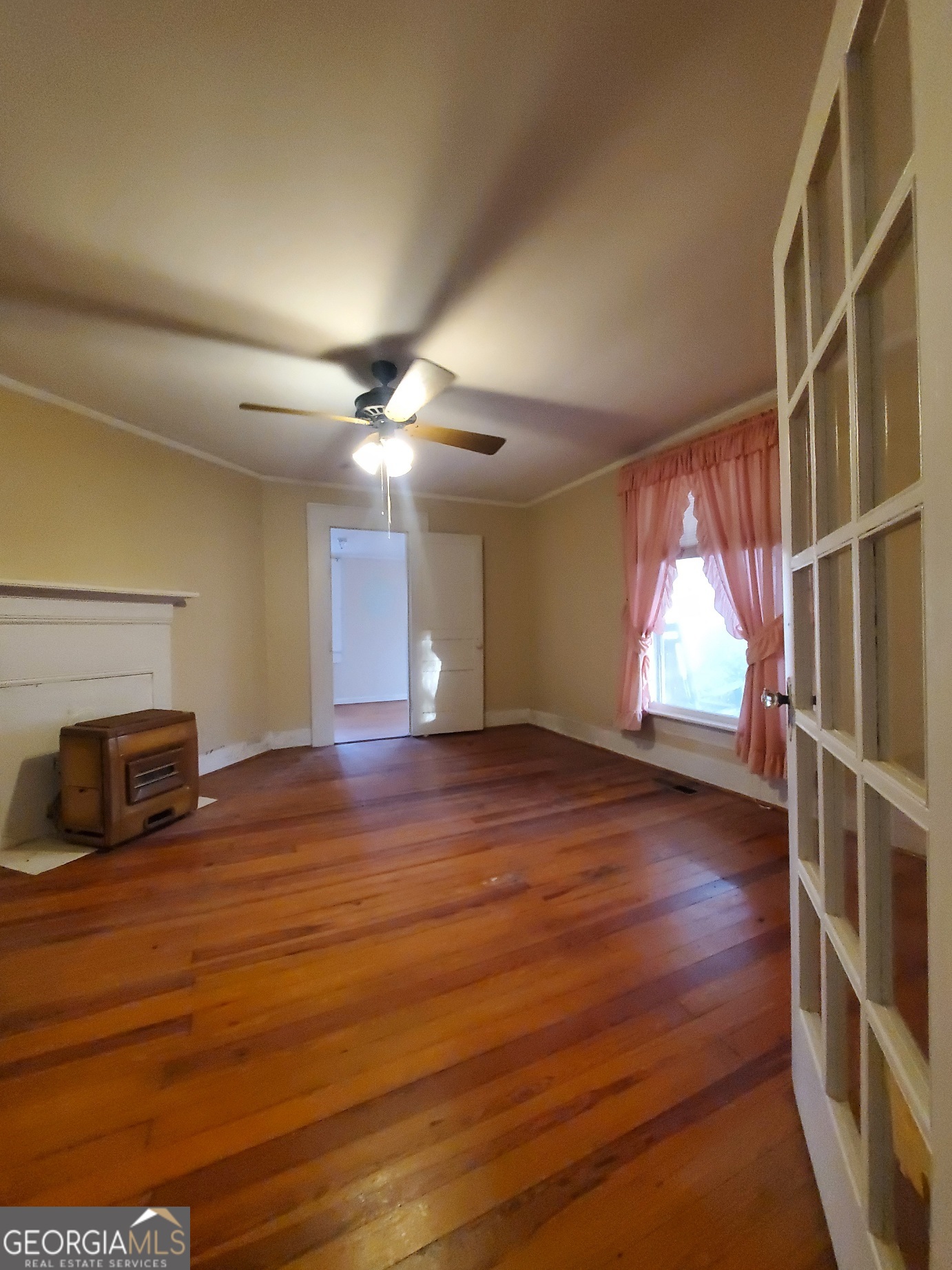 134 Adams Street Lavonia, GA 30553 - Photo 21 of 29 a view of an empty room with wooden floor and a window