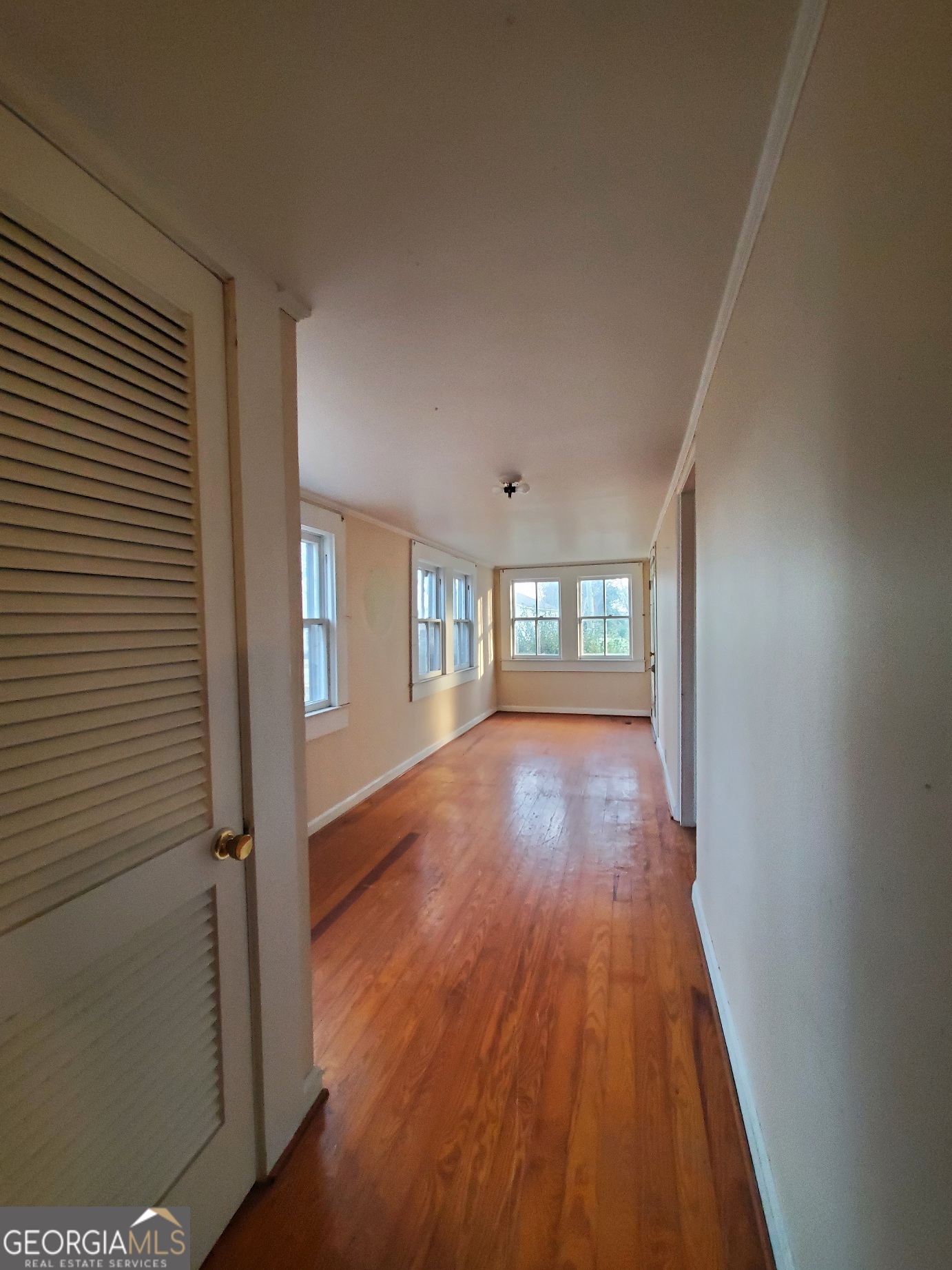 134 Adams Street Lavonia, GA 30553 - Photo 22 of 29 wooden floor in an empty room with a window