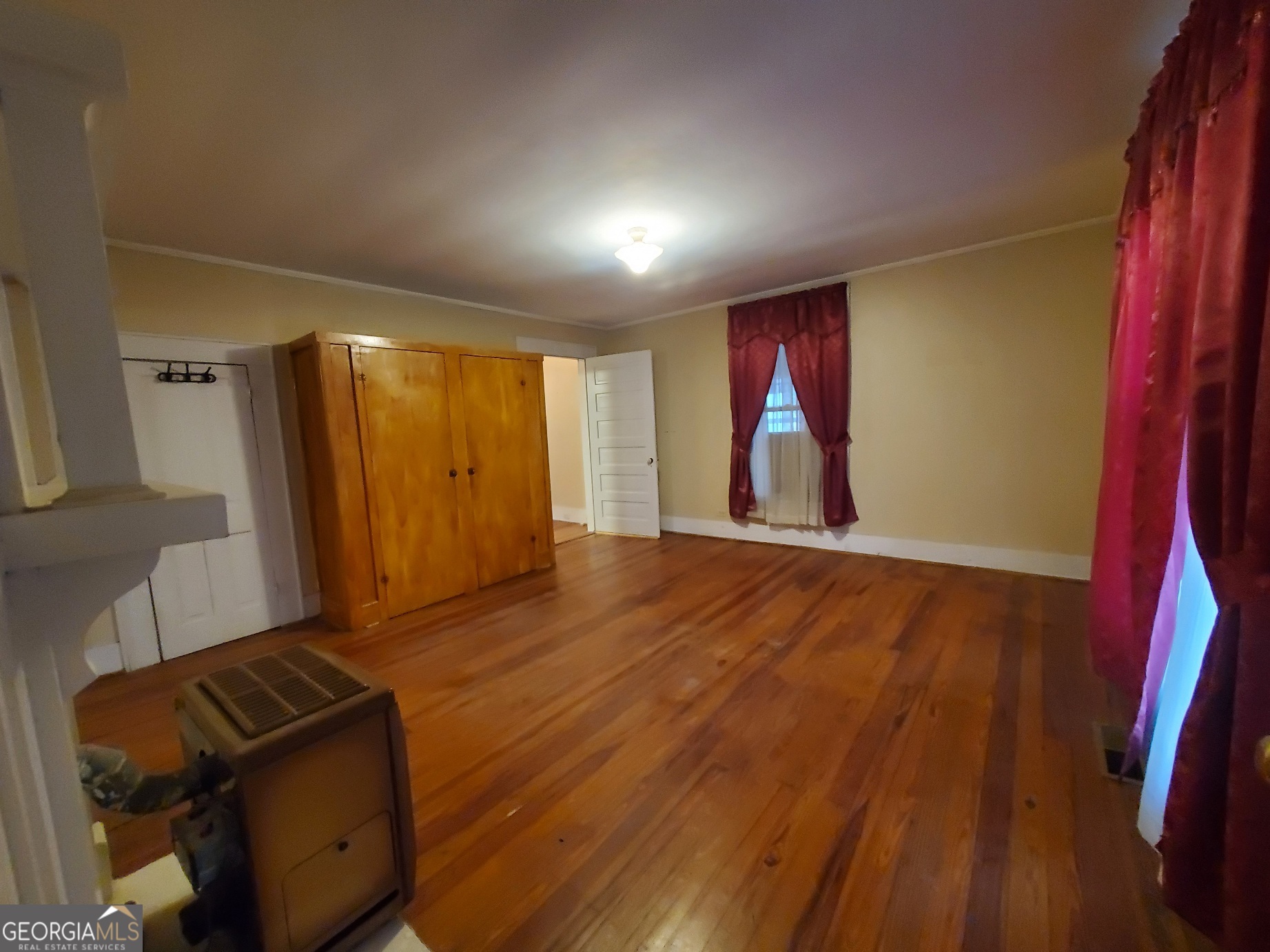 134 Adams Street Lavonia, GA 30553 - Photo 23 of 29 a view of an empty room with wooden floor and a window